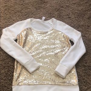 White long sleeve with golden sparkles.